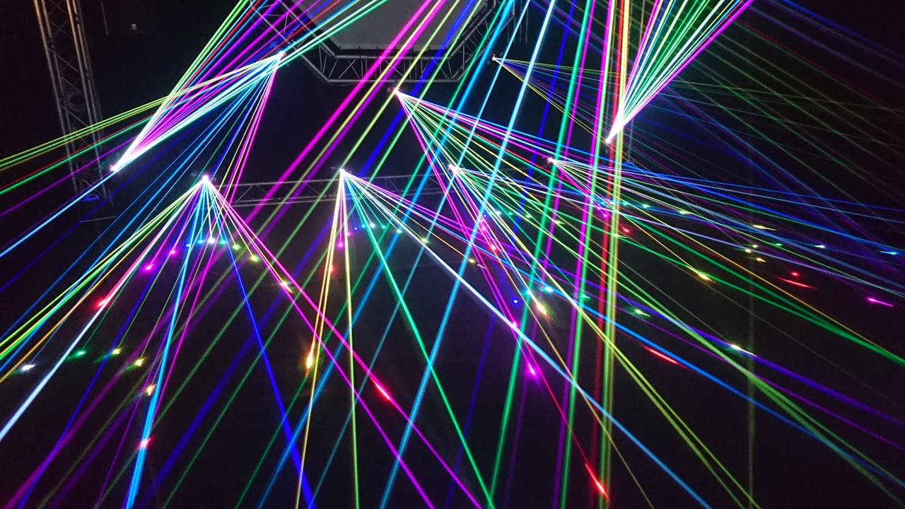 Dynamic multicolor laser beams create an electrifying display in a nighttime laser show.